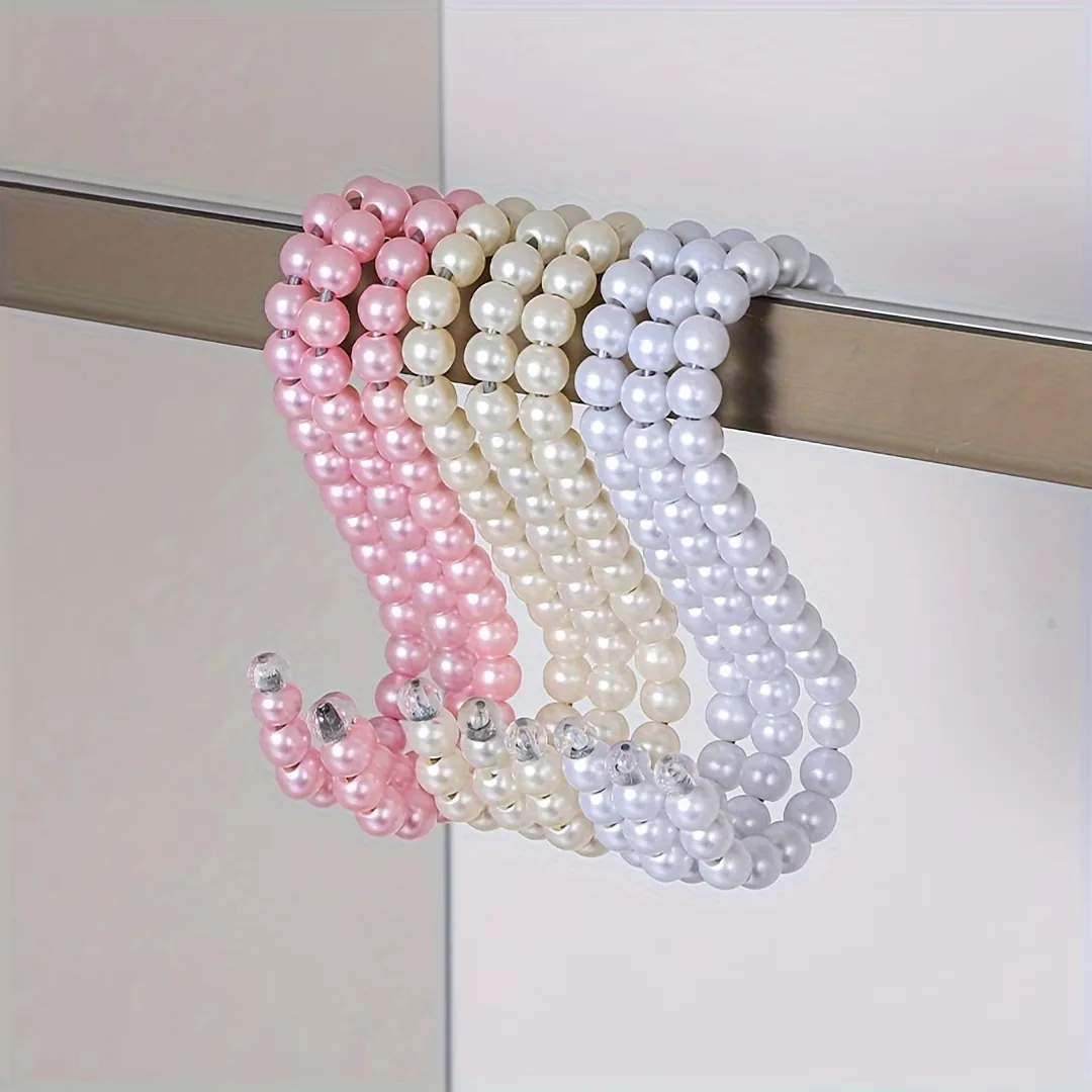 Handmade pearl beaded hangers in pink, ivory and pearl white on a wardrobe rail